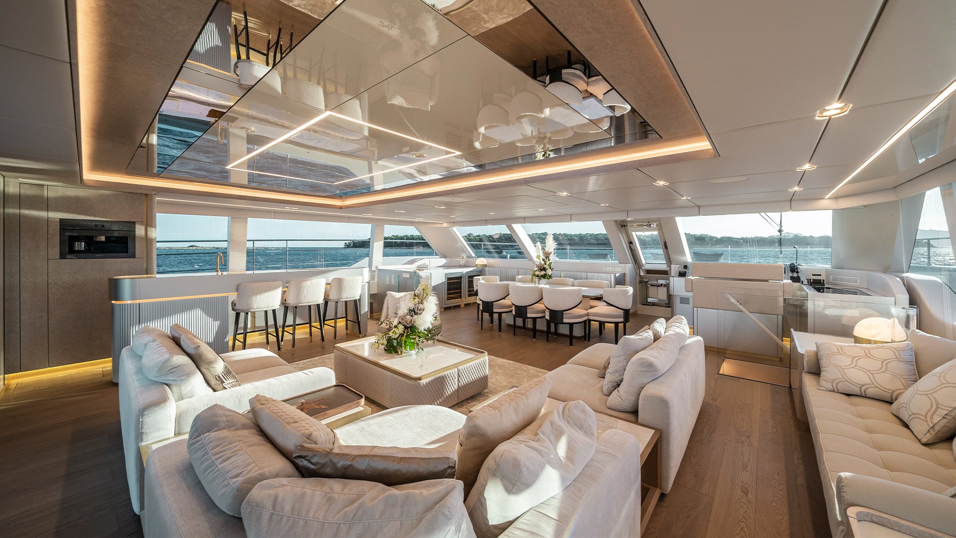 Elite_Awards_winner-02 Luxurious interior of a Sunreef Yachts catamaran featuring a spacious salon with modern furniture and large windows.